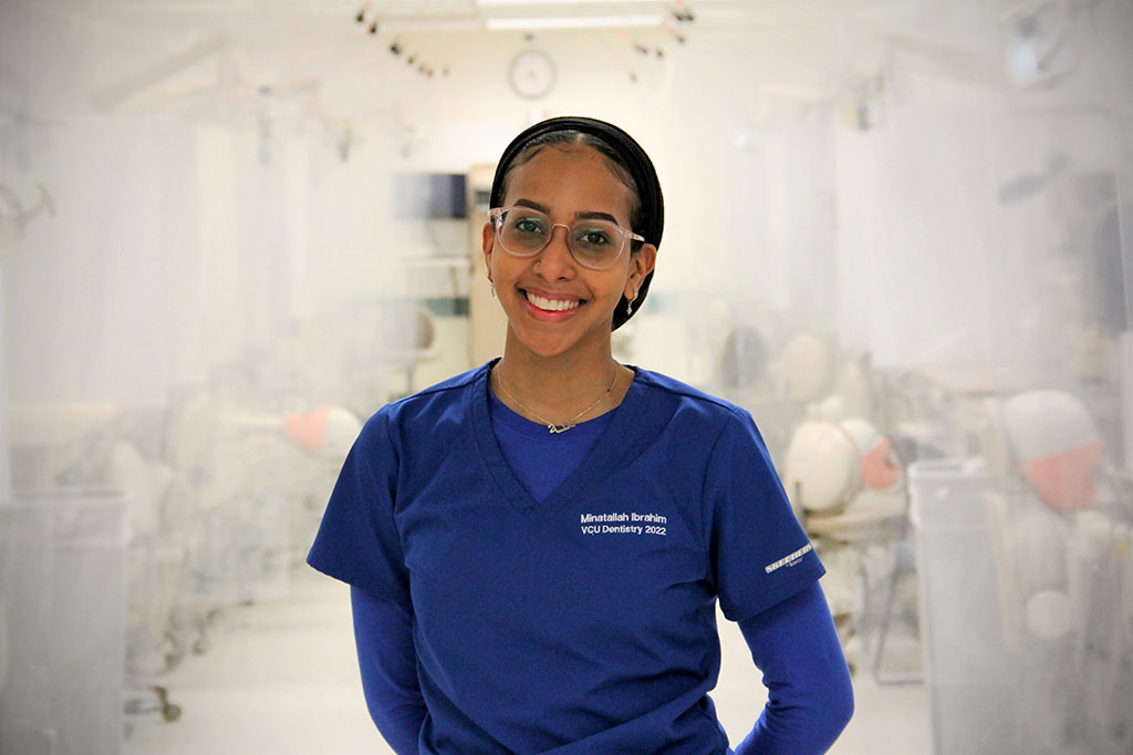 Dental student standing in simulation lab
